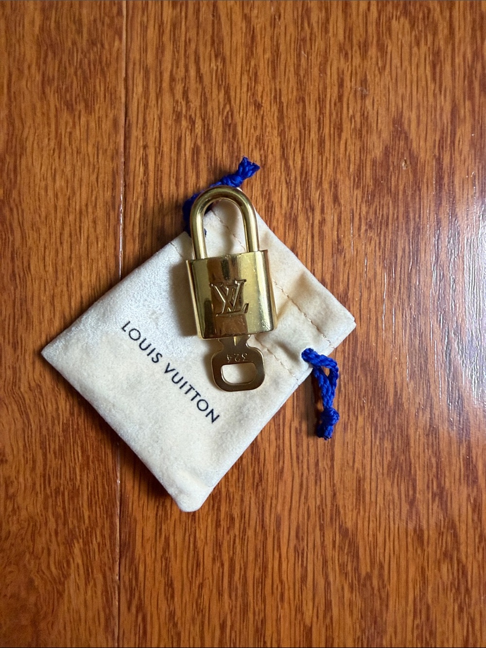 Louis Vuitton lock and Key with Cream Pouch number 324